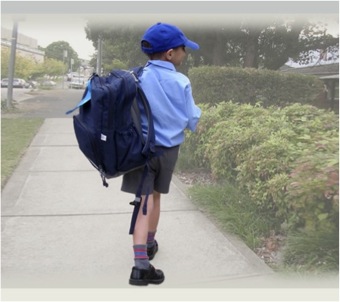 scoliosis in boy carrying schoolbag